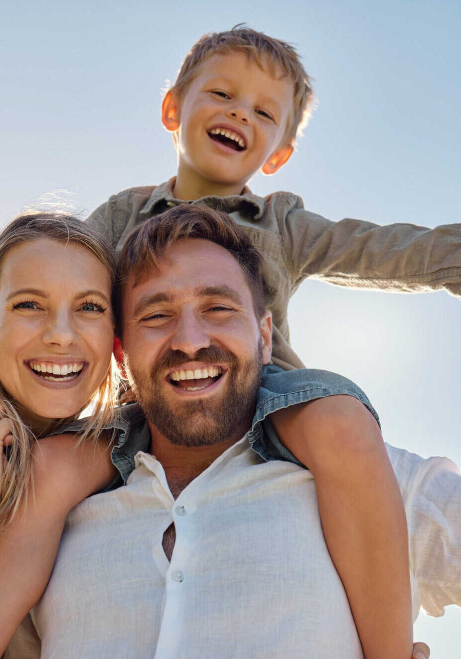 Family, mother and father with child, for holiday, vacation and being happy together outdoor. Portrait, mama and dad with kid for quality time, travel and bonding being loving, carry boy and have fun